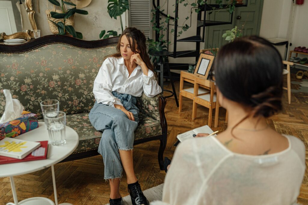 A woman and a grief coach sit in an office.