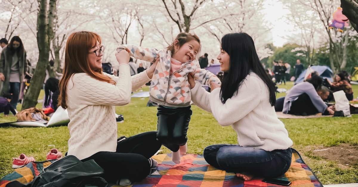 Two people and a child at a park.
