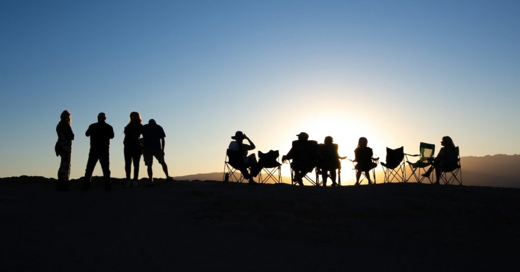 A group of friends watching the sunset. 